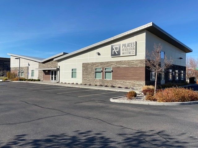 A large building with a parking lot in front of it.