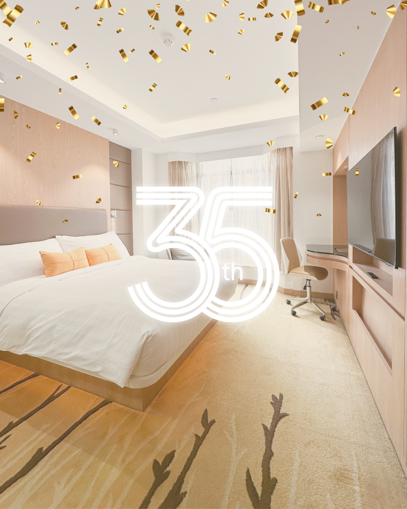 Bright bedroom with “35 Anniversary” text, white bed, beige decor, and gold confetti ceiling accents