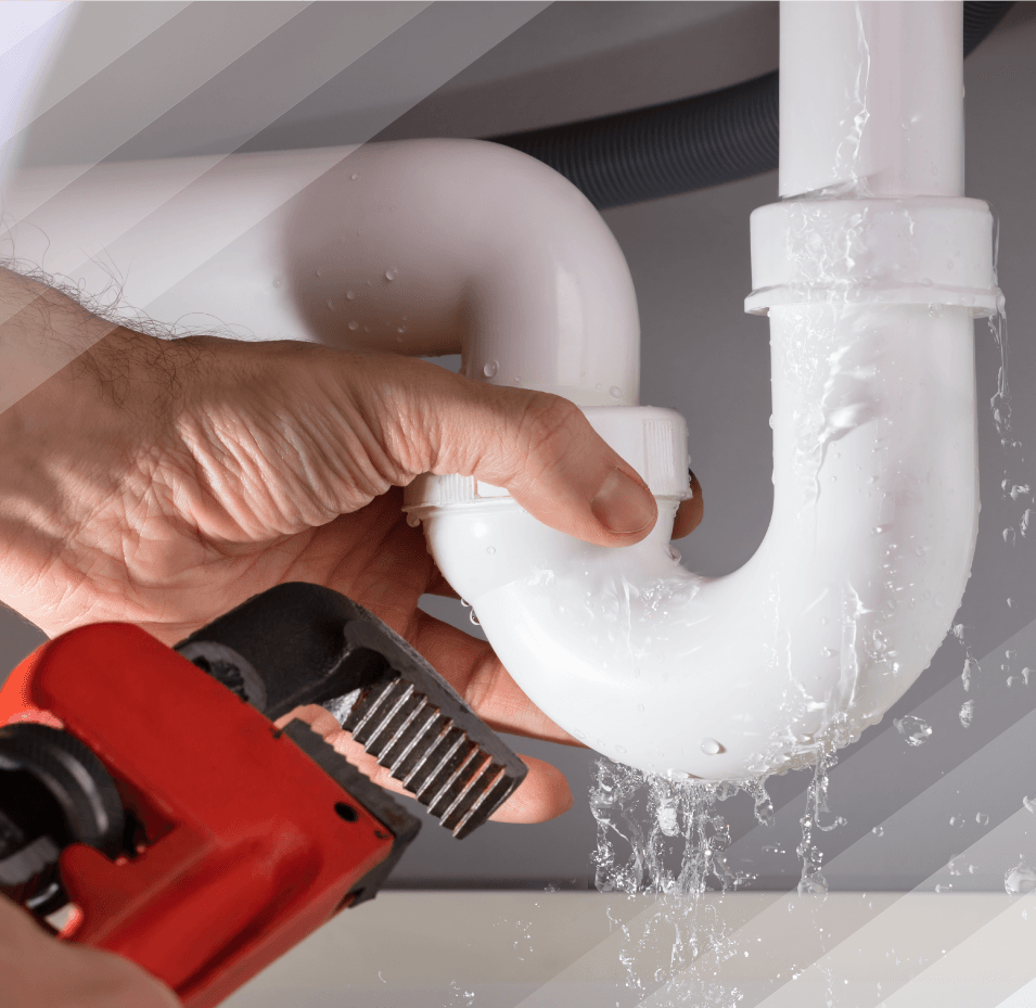 A person is fixing a sink pipe with a wrench.