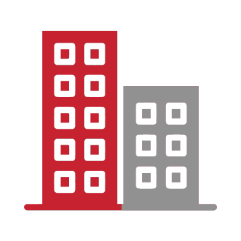 Two buildings , one red and one gray , are sitting next to each other on a white background.