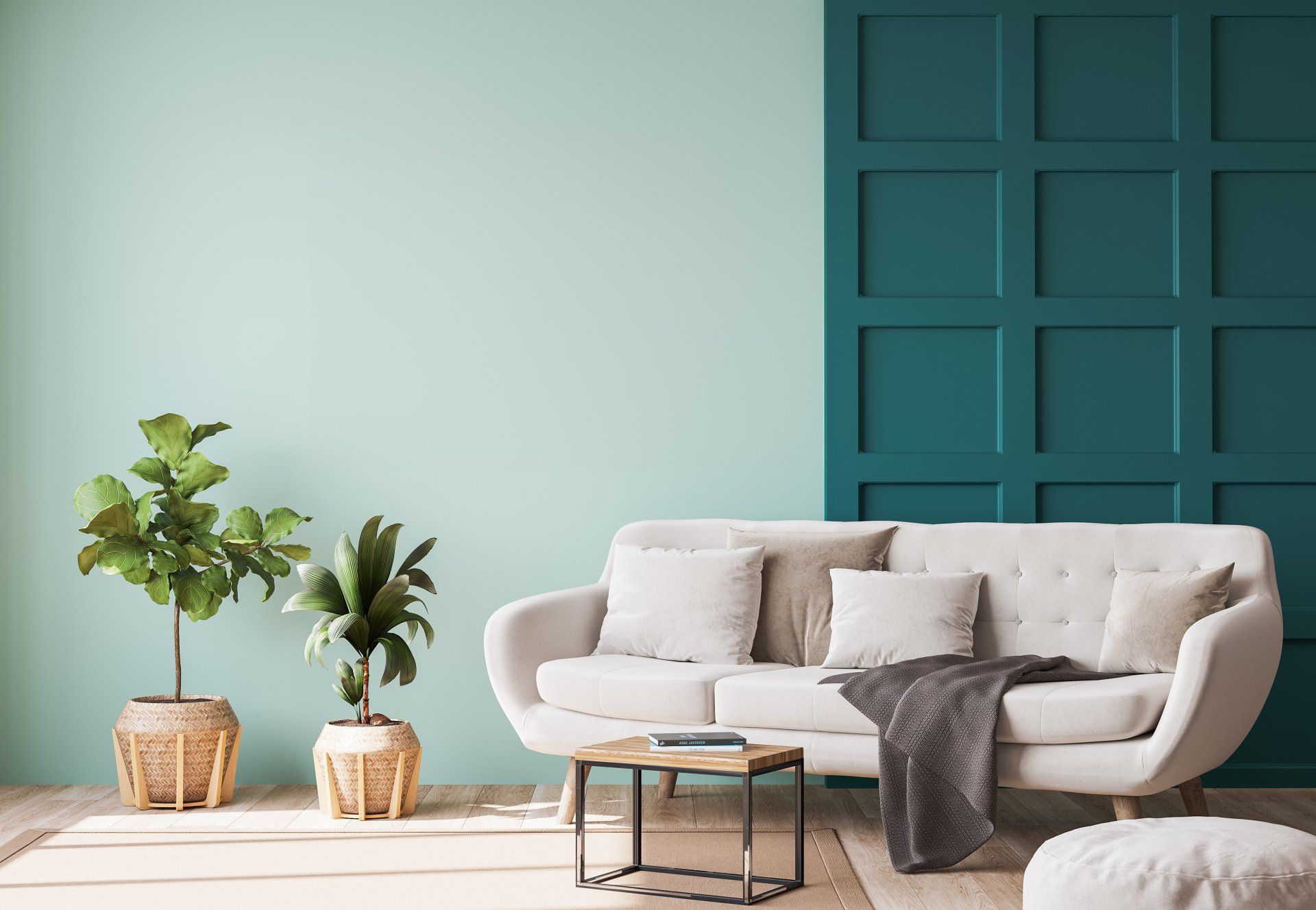 A living room with a white couch and green walls.