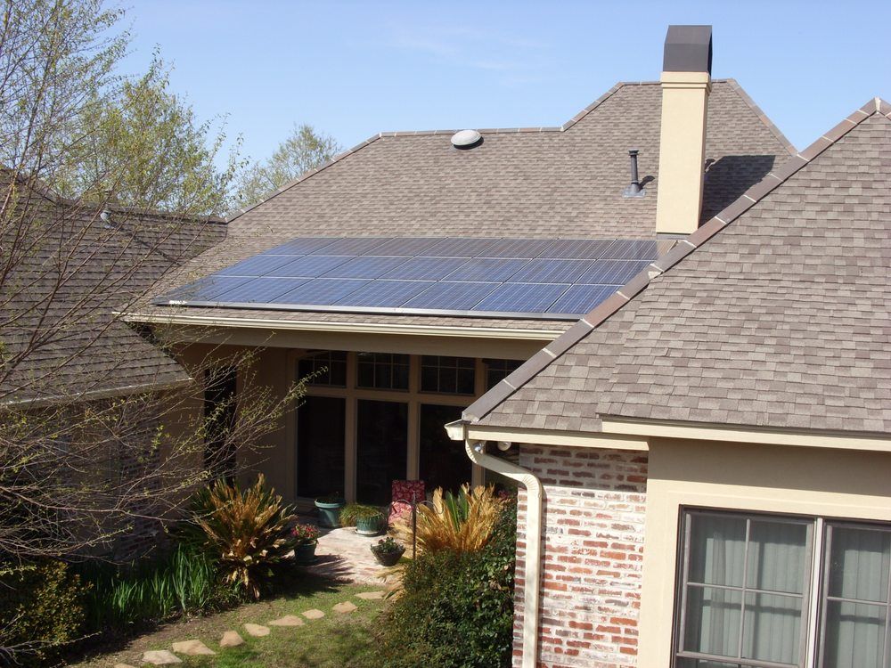 A brick house with solar panels on the roof