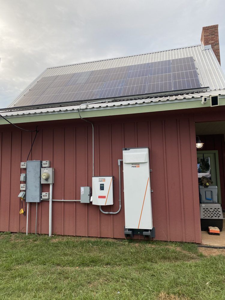 A house with a lot of solar panels on the roof