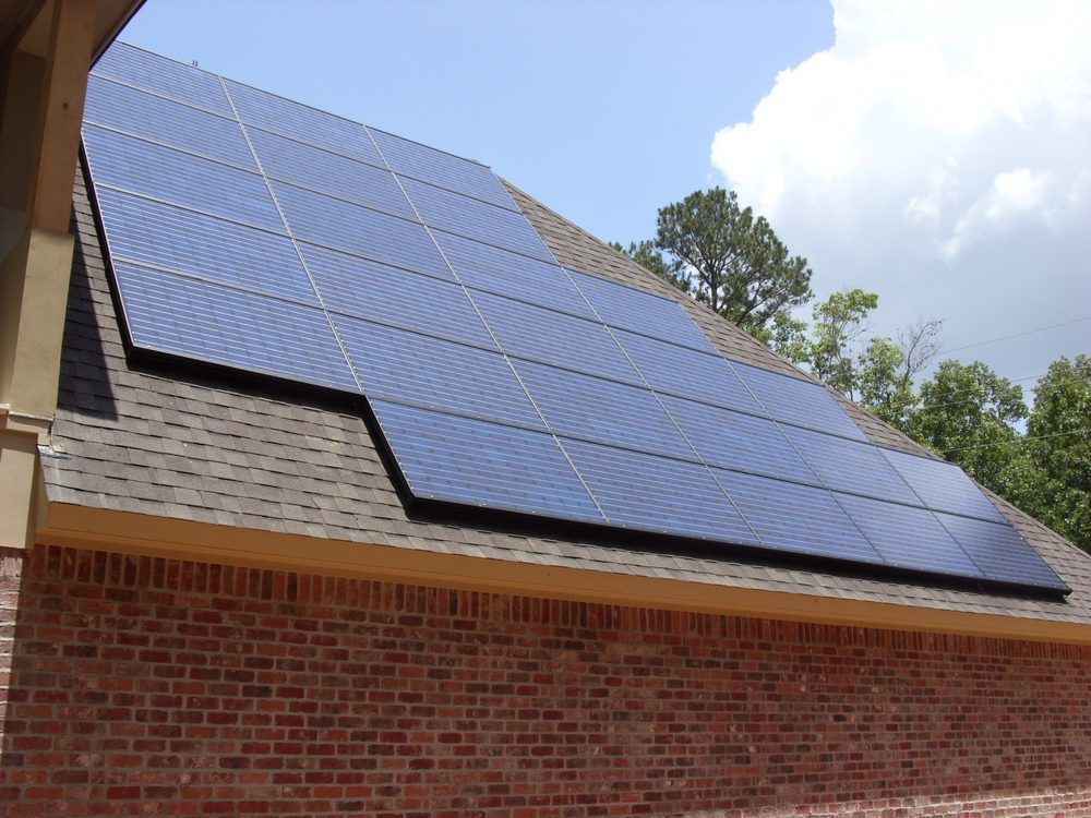 A brick building with solar panels on the roof