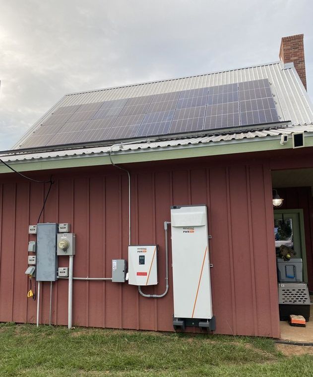 A red house with solar panels on the roof