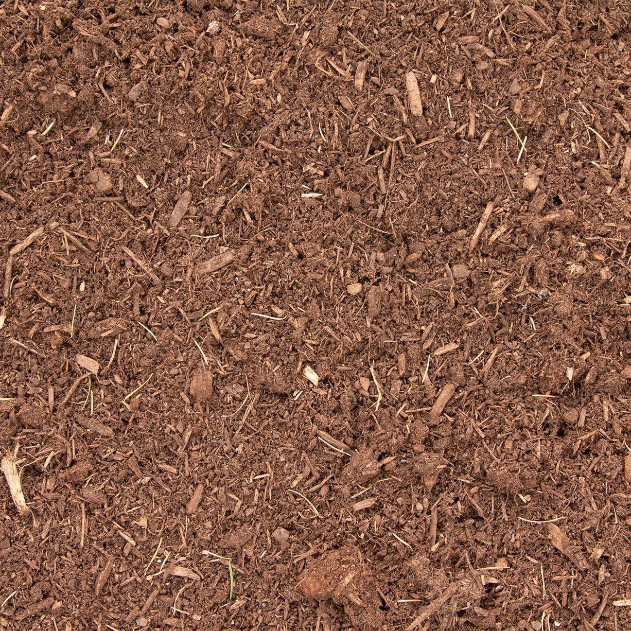 Close-up of brown wood mulch texture with small bark chips and debris