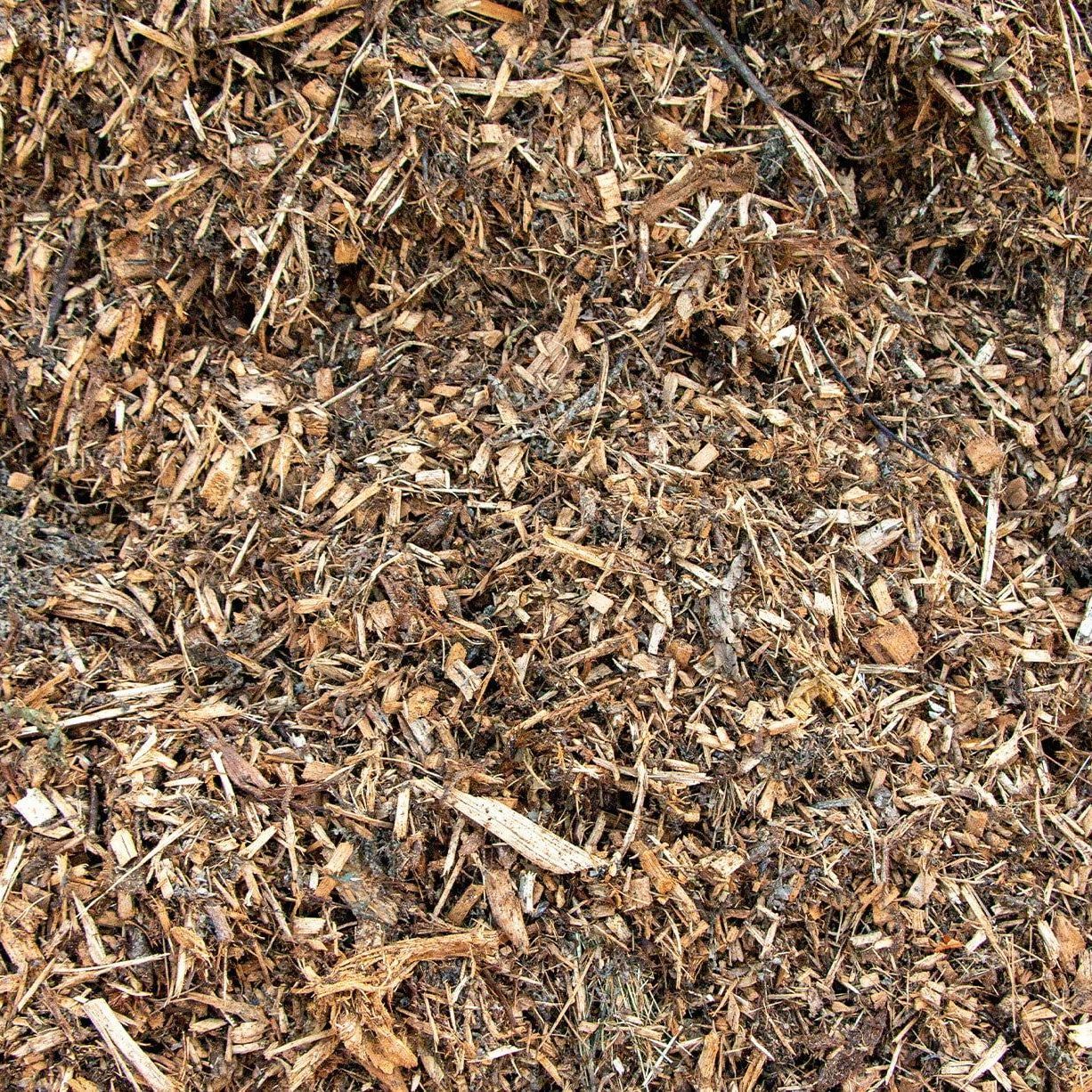 Close-up of brown mulch and wood chips with small sticks scattered throughout