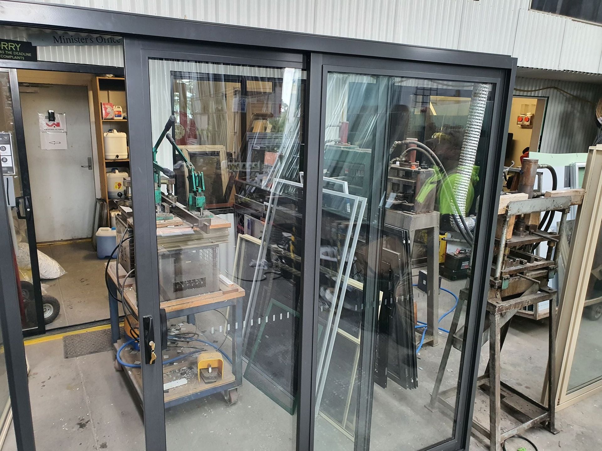 A Dark-framed Sliding Glass Door Stands in a Workshop — Channel Glazing In Electrona, TAS