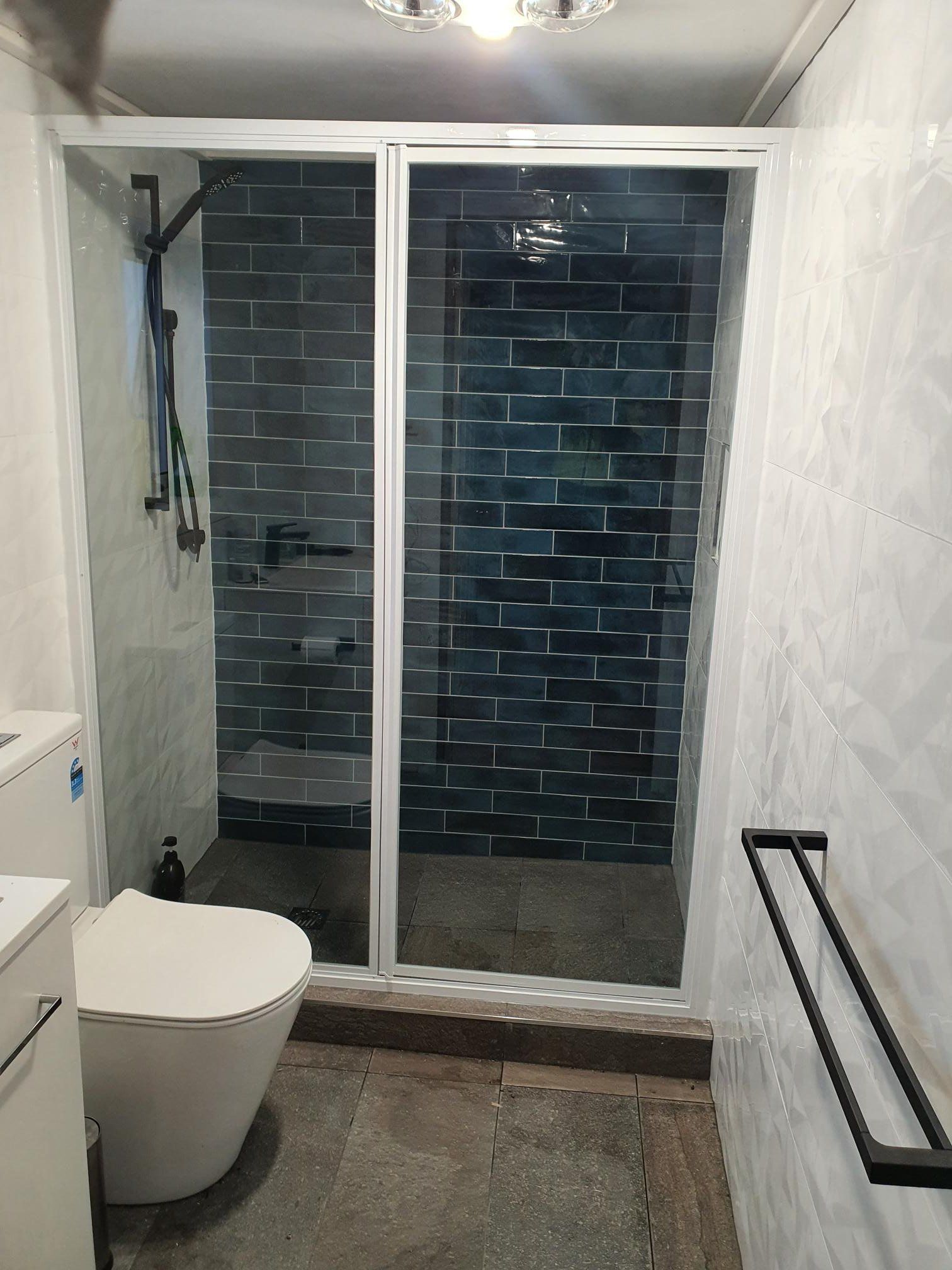 A Bathroom Featuring a Shower With Dark Blue Subway Tiles — Channel Glazing In Electrona, TAS