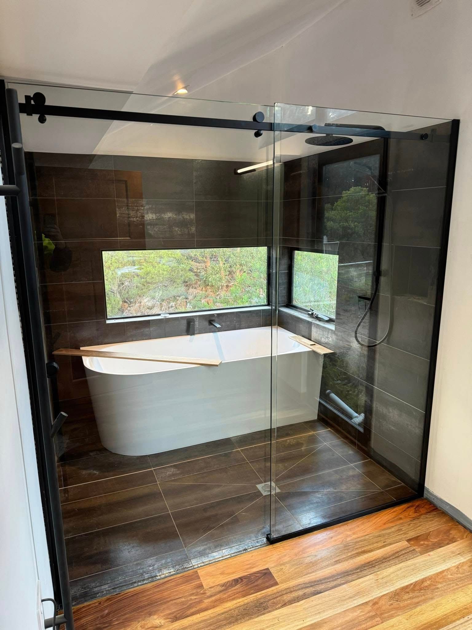 A Modern Bathroom With a Freestanding White Bathtub — Channel Glazing In Electrona, TAS