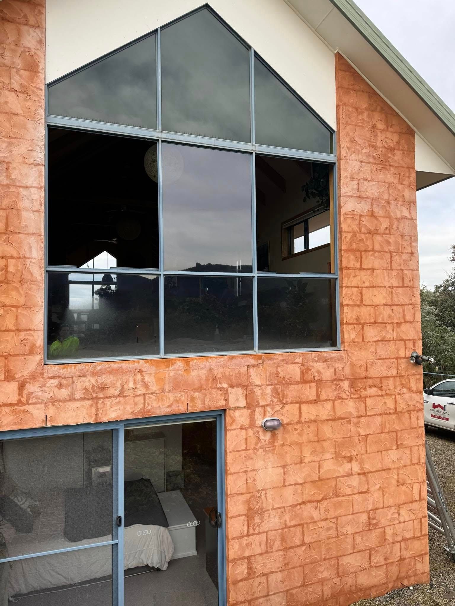 An Orange Stone Building With a Large Triangular Window — Channel Glazing In Electrona, TAS