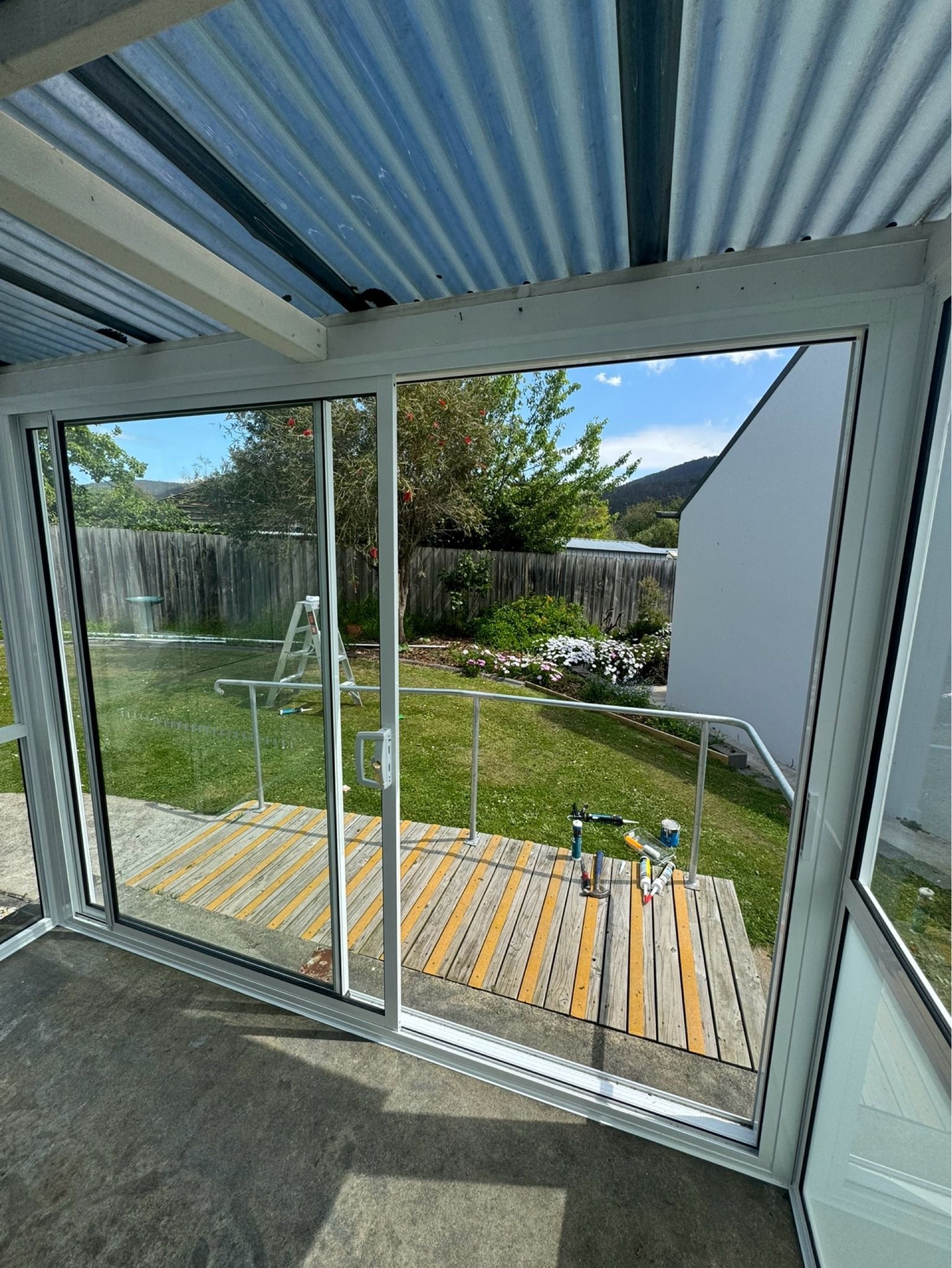 View From Inside a Sunroom Through Large White-framed Sliding — Channel Glazing In Electrona, TAS