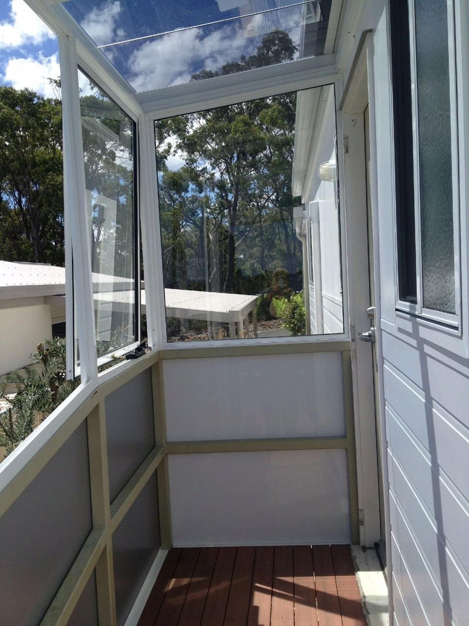 A Narrow, Enclosed Porch With a Wooden Floor, White Panels — Channel Glazing In Electrona, TAS