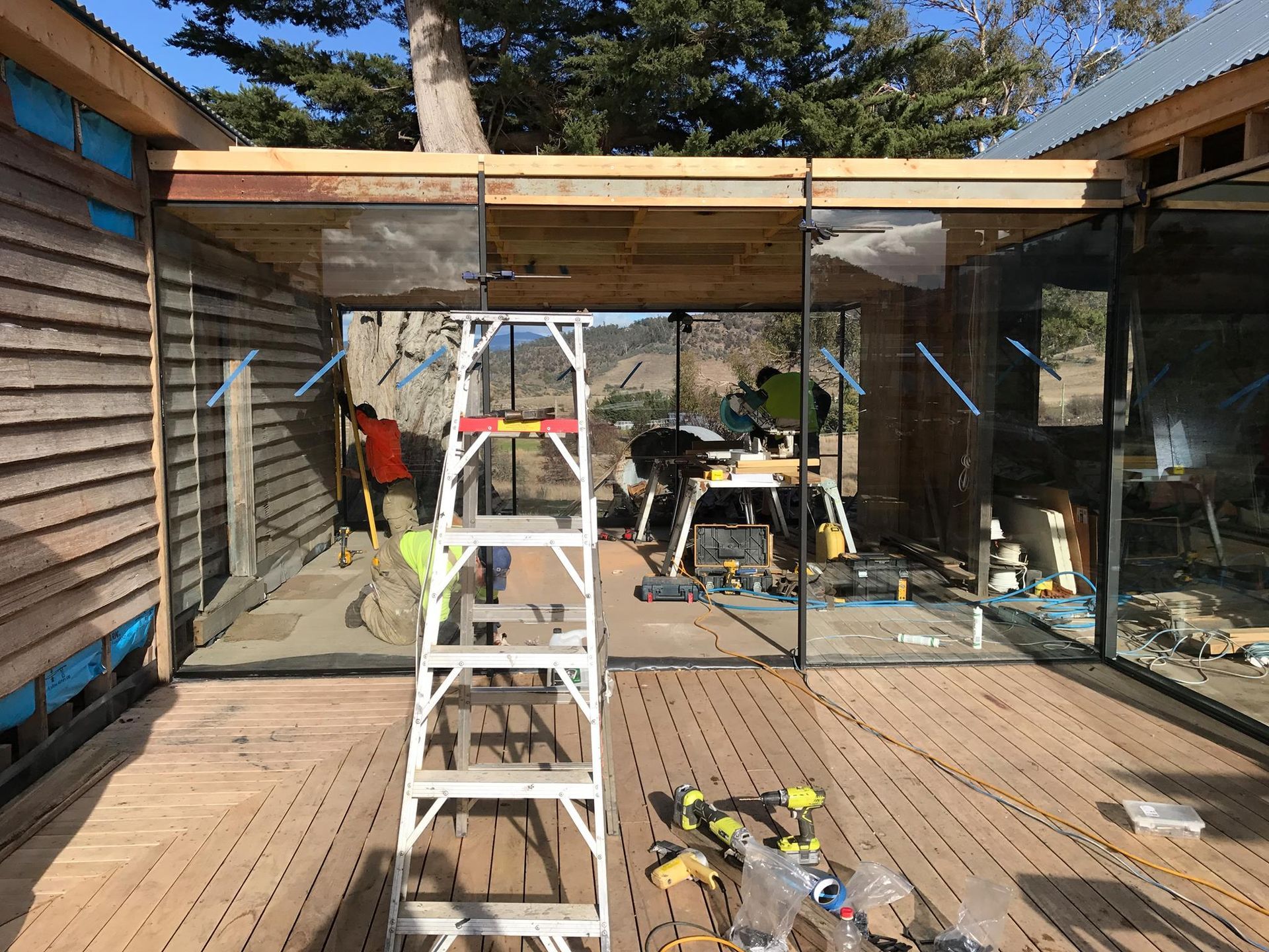 Workers Build a Wooden Deck and Structure With Glass Walls — Channel Glazing In Electrona, TAS