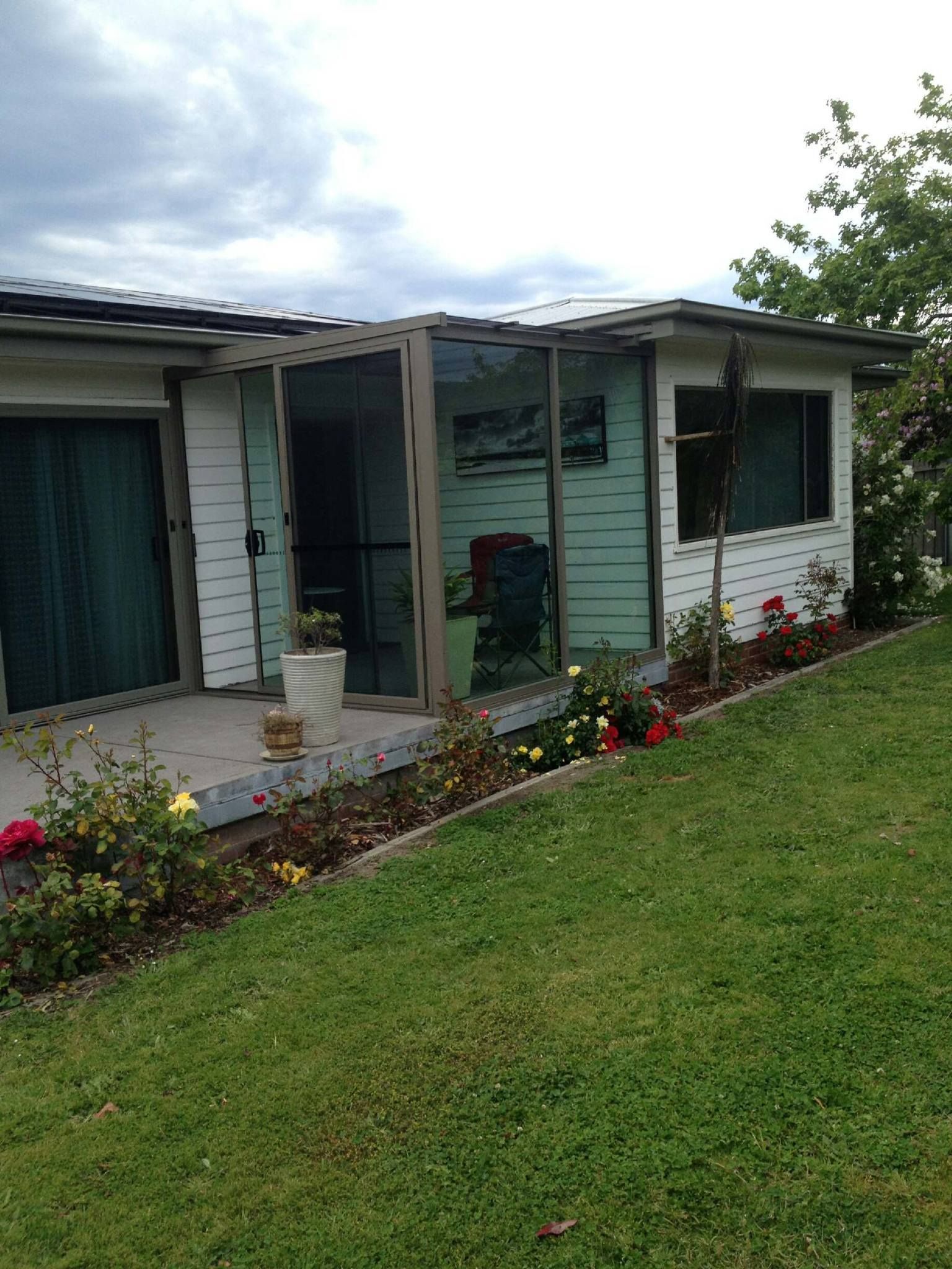 A House Exterior Featuring a Screened-in Porch With Light Green Walls — Channel Glazing In Electrona, TAS