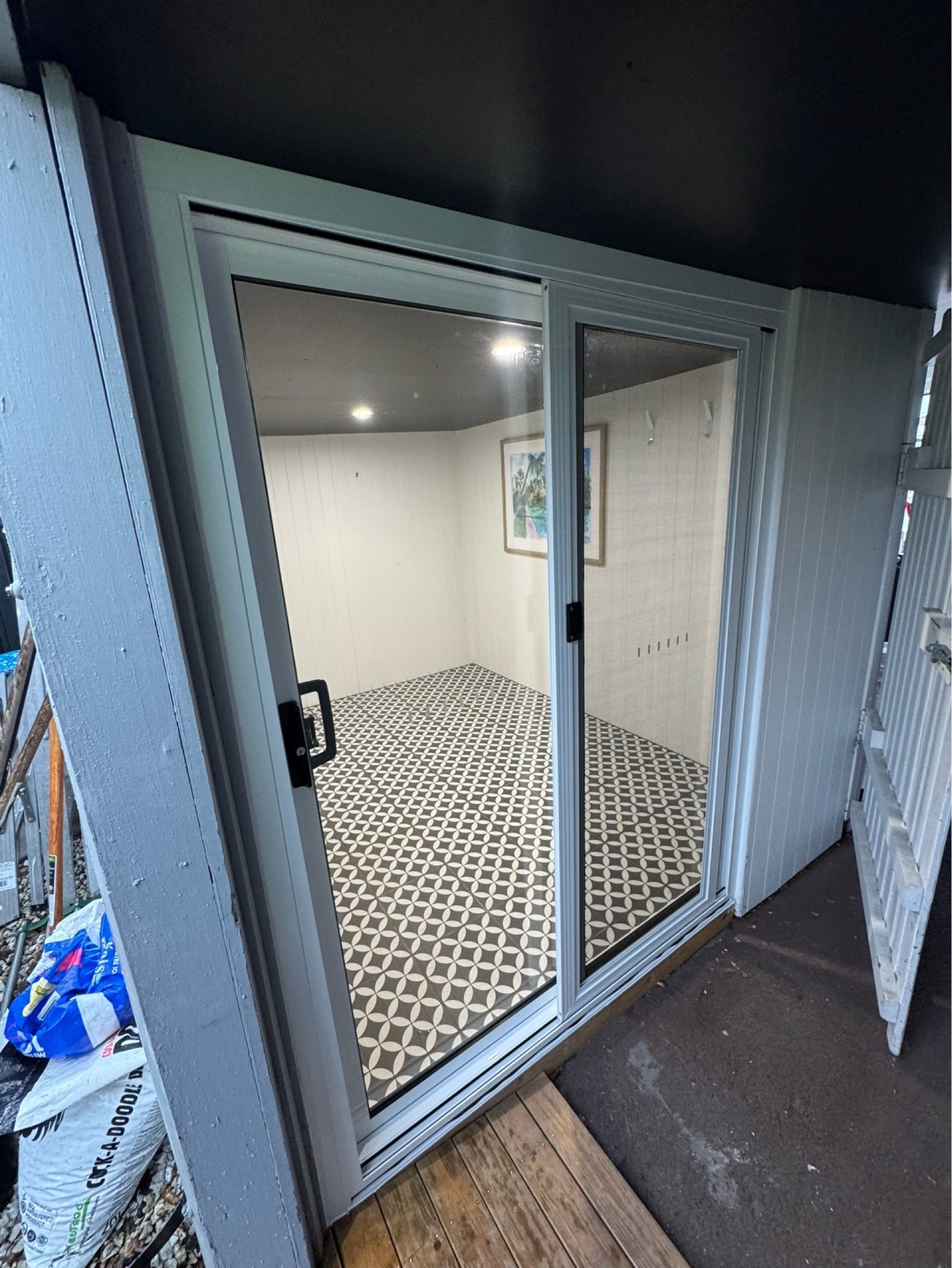 A Sliding Glass Door Opens Into a Room With Patterned Tile Floors — Channel Glazing In Electrona, TAS