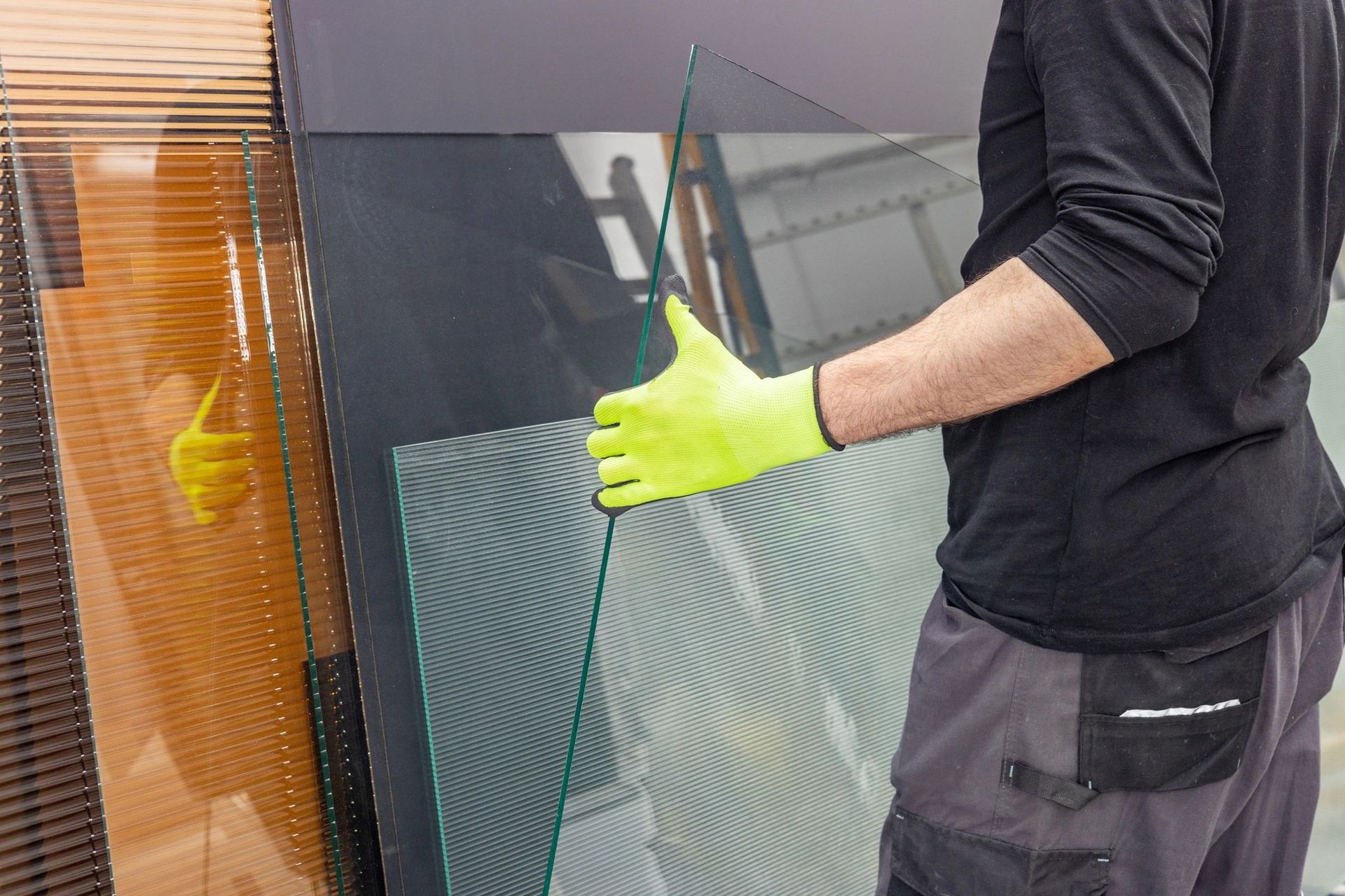 A Person Wearing Bright Yellow Safety Gloves Handles a Large — Channel Glazing In Electrona, TAS