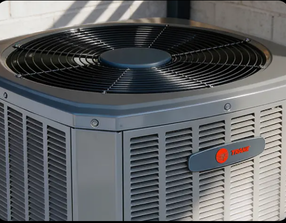 Gray Trane HVAC outdoor unit with black fan grille on top