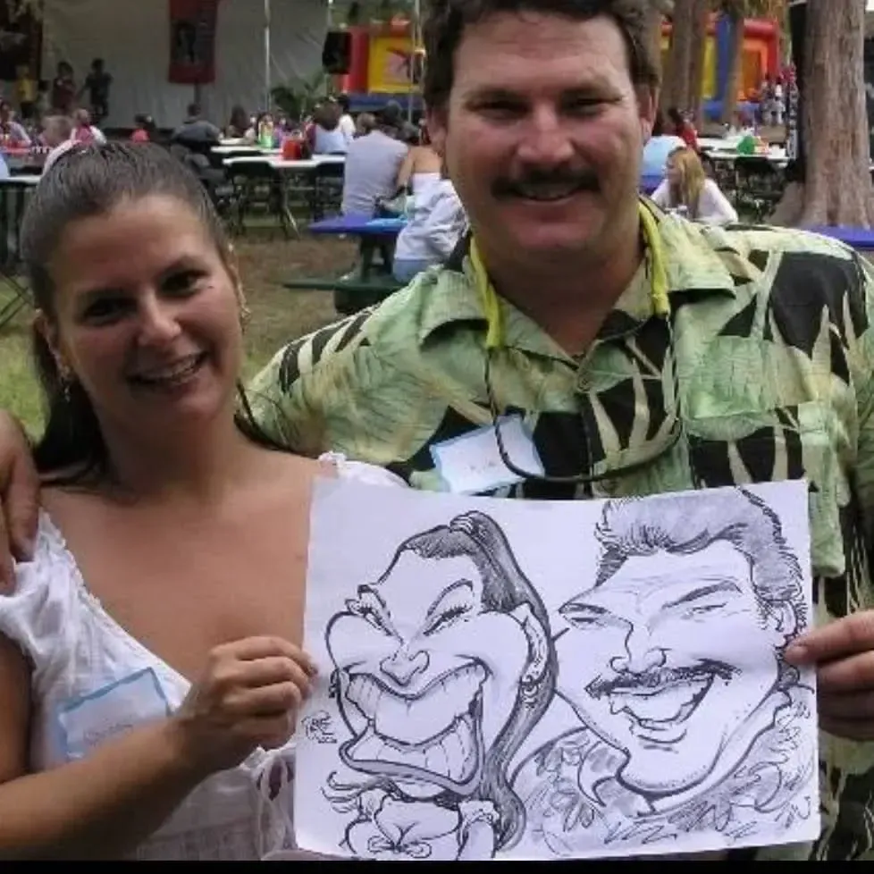 A man and a woman holding a drawing of a man and a woman