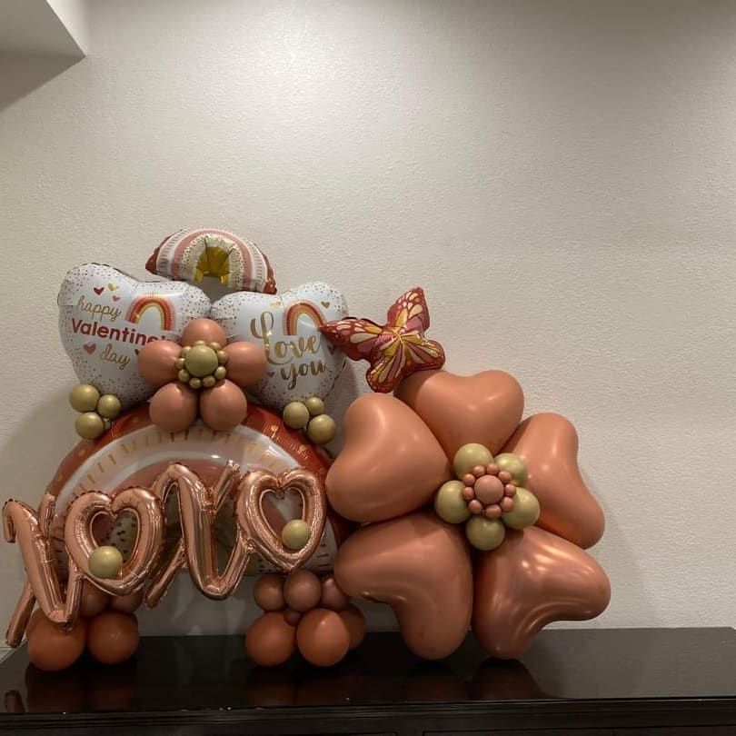 A bunch of balloons are sitting on top of a table.
