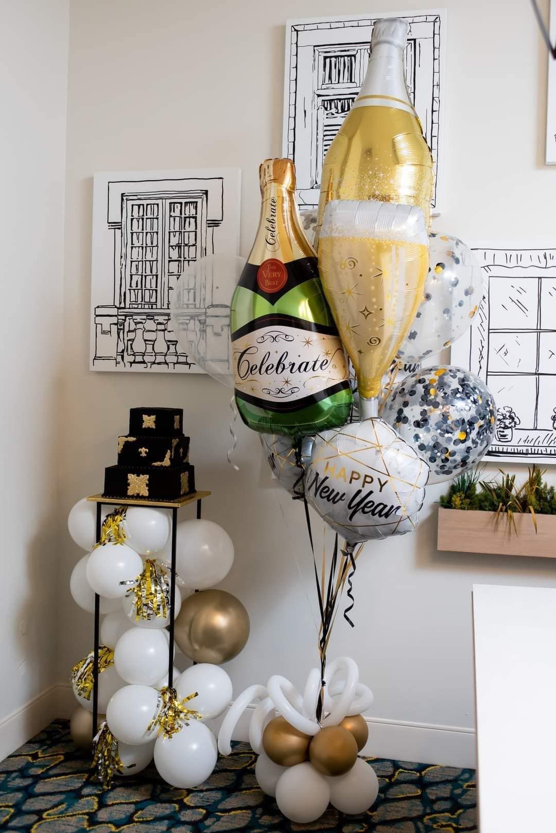 A bunch of balloons shaped like champagne bottles are sitting on top of each other in a room.
