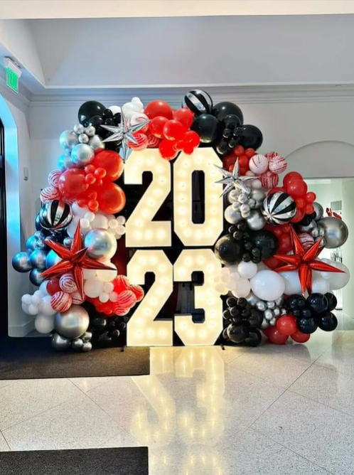 A large sign with the number 20 and 23 surrounded by balloons