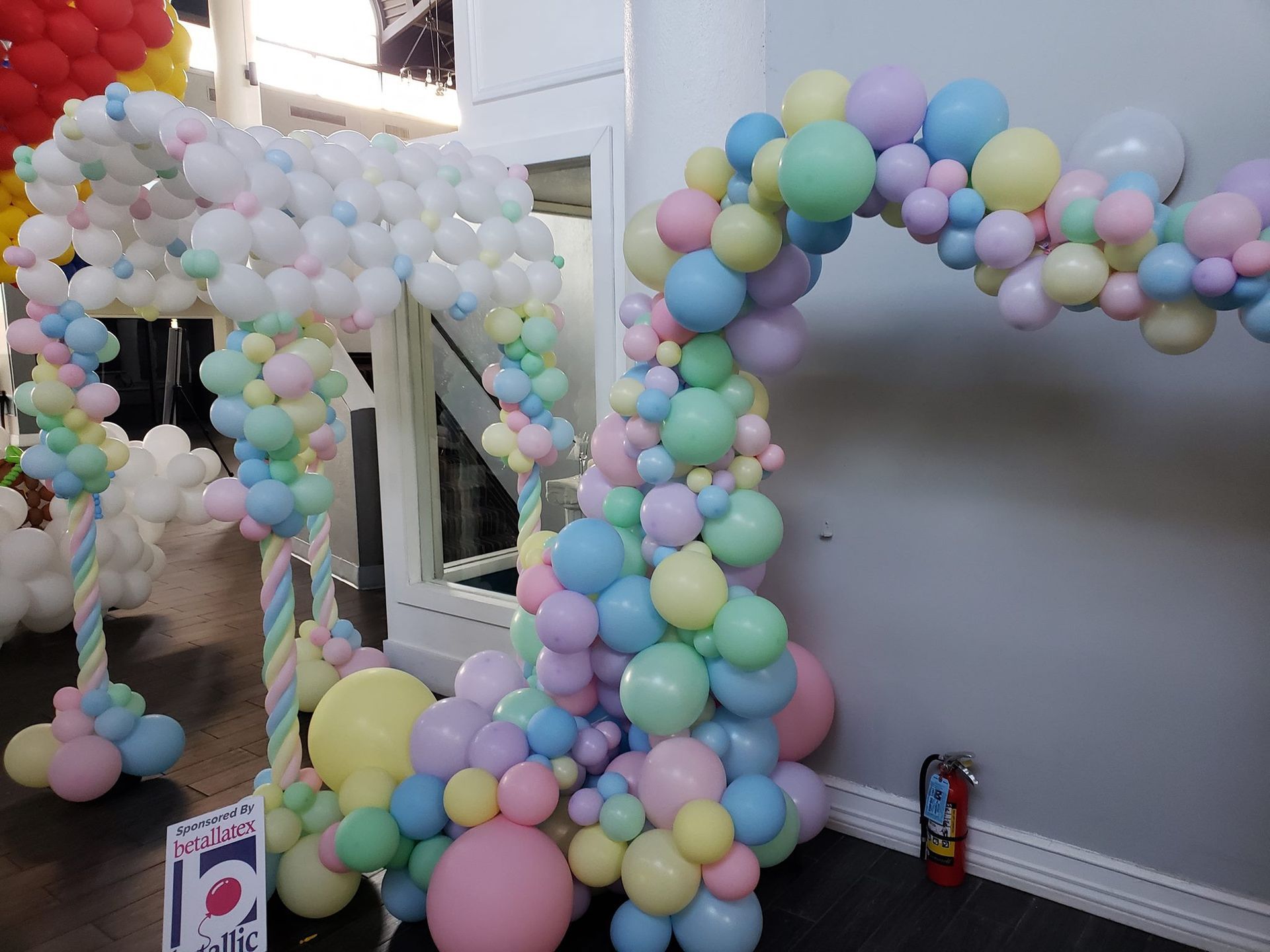 A room filled with balloons and a fire extinguisher.