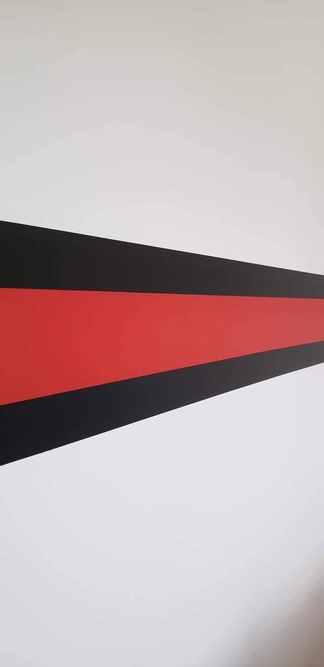 Abstract red, black, and gray triangular geometric shapes on a light background