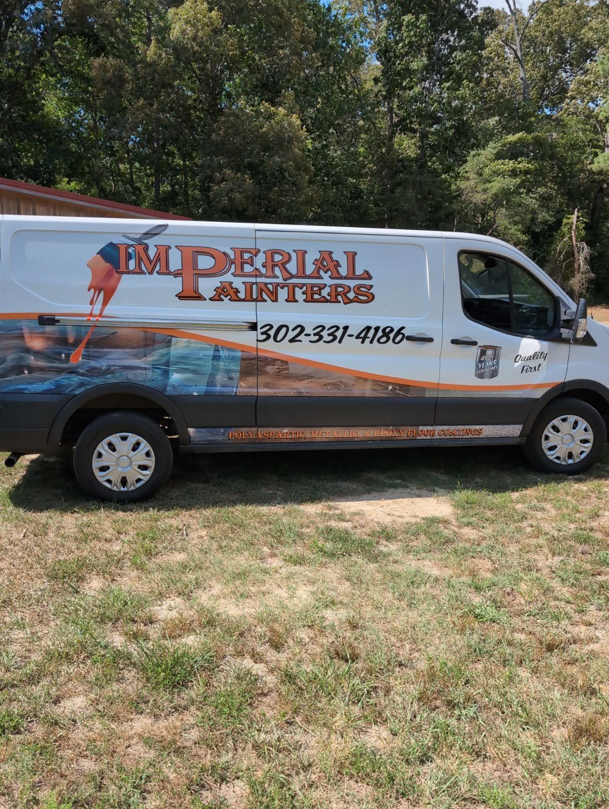 Imperial Painters van parked on grass with company logo and phone number