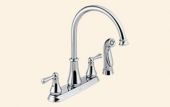 A close up of a kitchen sink faucet on a white background.