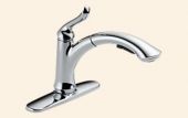 A chrome kitchen faucet with a pull out sprayer on a beige background.