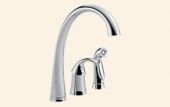 A close up of a kitchen sink faucet on a white background.
