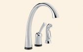 A kitchen sink faucet with a sprayer attached to it.