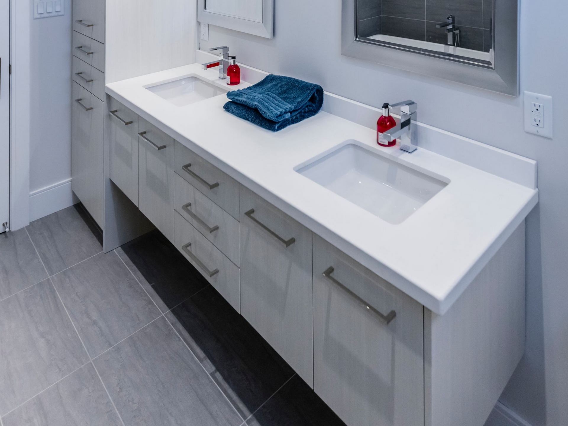 Bright, modern bathroom with a double vanity sink, white countertops