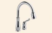 A chrome kitchen faucet with a handle on a white background.