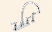 A chrome kitchen sink faucet with a sprayer attached to it.