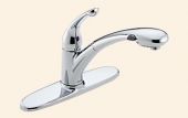 A close up of a chrome kitchen sink faucet on a beige background.