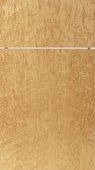 A close up of a piece of wood with a string hanging from it.
