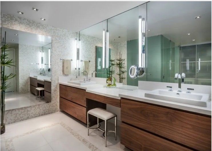 A bathroom with two sinks and a large mirror