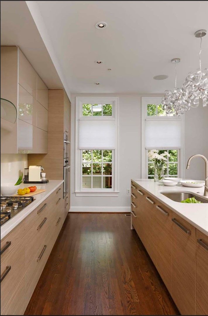 A kitchen with wooden cabinets and white counter tops