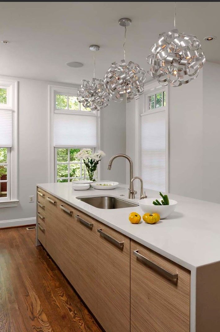 A kitchen with wooden cabinets and a stainless steel sink