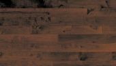 A close up of a wooden floor with a dark background.