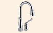 A close up of a kitchen faucet on a white background.
