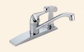 A close up of a chrome kitchen sink faucet on a beige background.