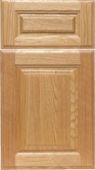 A close up of a wooden cabinet door on a white background.
