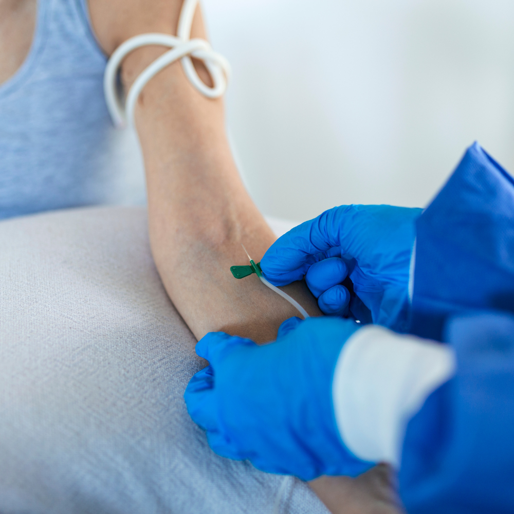 A close up of a person getting an injection in their arm.