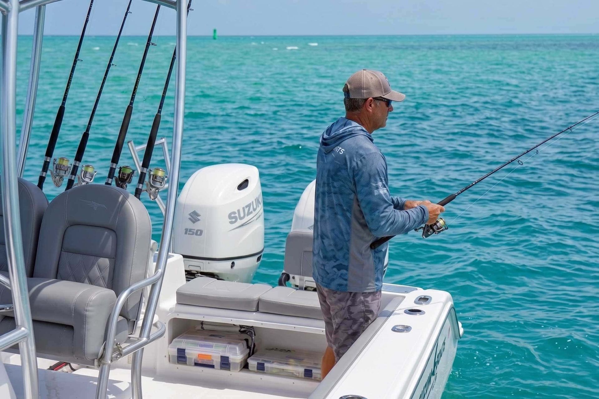 Man fishing from a boat on turquoise ocean water, with a Suzuki outboard motor visible.