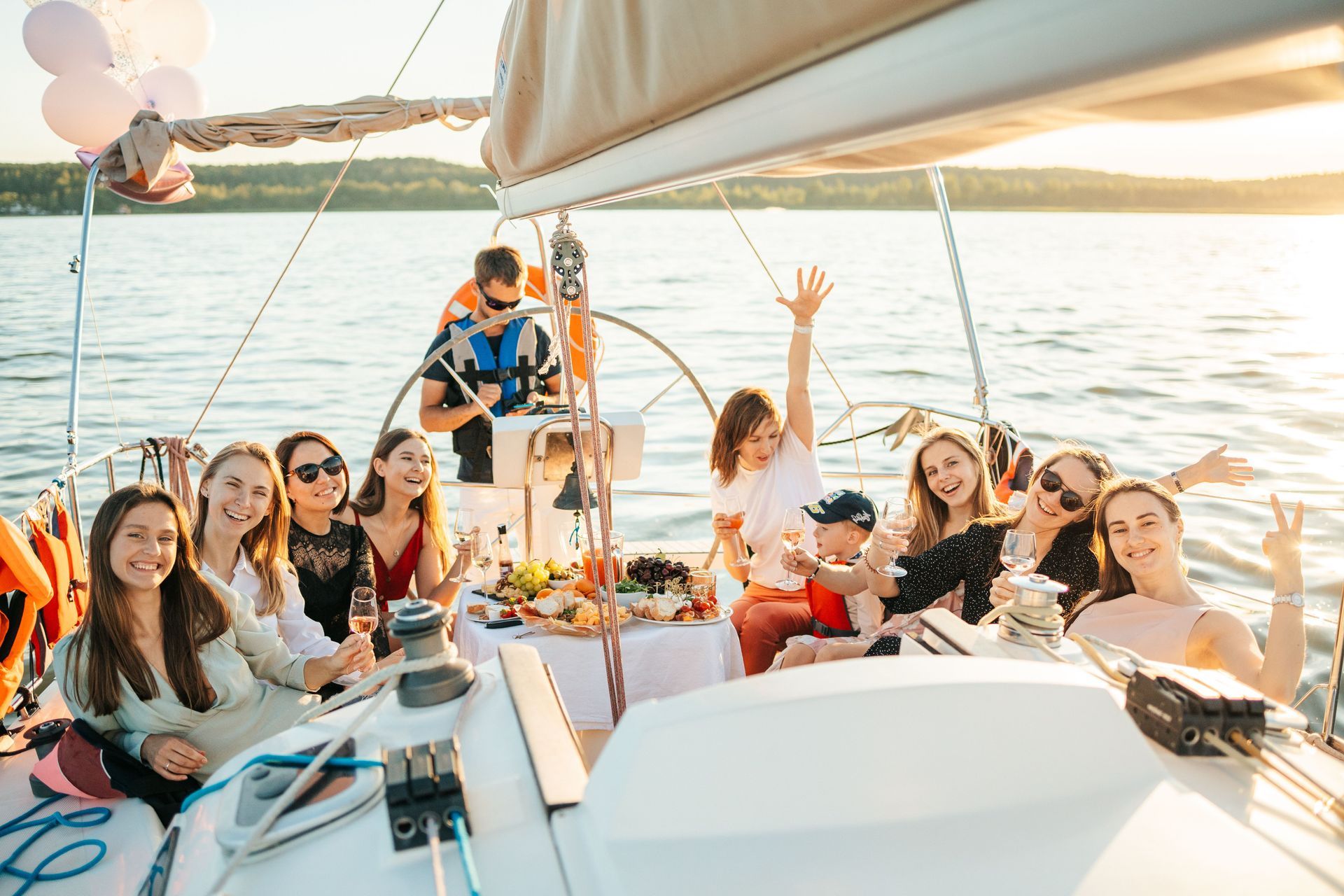 Family enjoying sunset on catamaran deck.