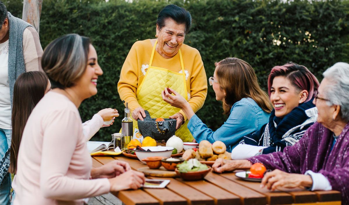 elderly woman having a barbeque with her family
