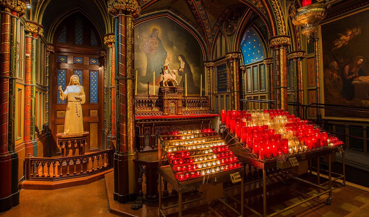 Front of a Catholic church showing a beautiful altar with hundreds of lit candles